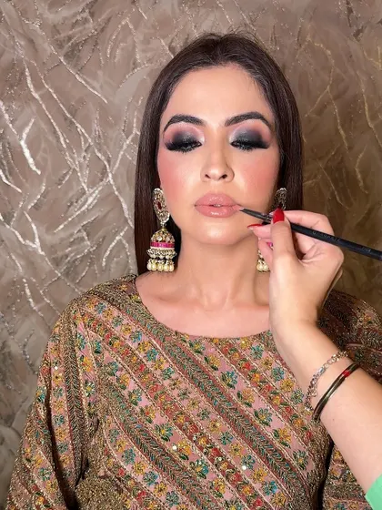 A behind the scenes shot of the lip application. For a heavy smokey eye, I often choose a soft nude lipstick to keep the focus on the eyes and maintain a perfect balance in the overall look.