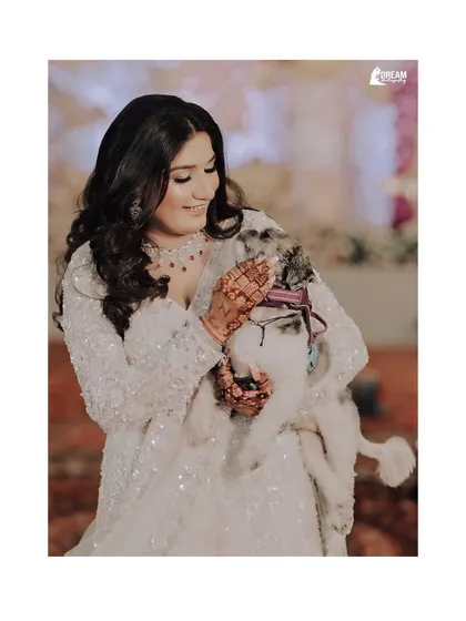 A heartwarming moment as bride Nidhi shares a cuddle with her adorable pet during her Sagan ceremony.