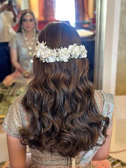 The back view showcases the beautiful floral crown and the soft, flowing waves.