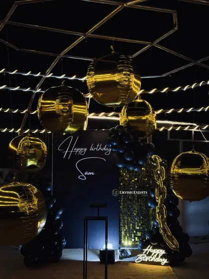 For those who love a touch of drama and sophistication. This black and gold themed birthday bash features a stunning backdrop, neon signs, and metallic balloons for a truly glamorous night.