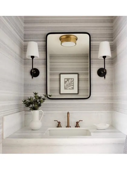 The 'Sandia' striped wall covering creates a cool, calm, and clean aesthetic in this powder room. The horizontal lines can make a small space feel wider, and the neutral palette is serene and sophisticated.
