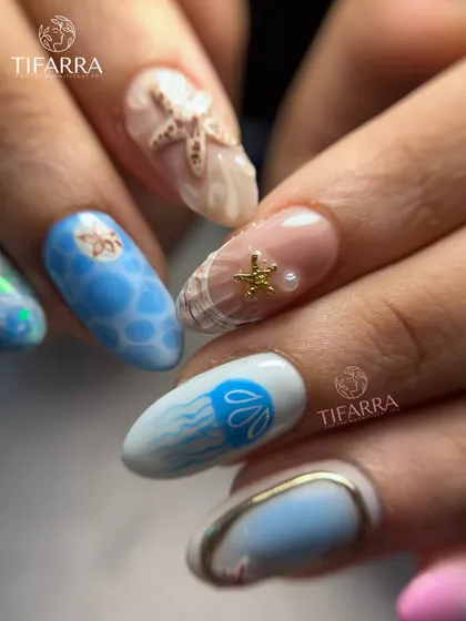 A view of the hand-painted jellyfish and 3D seashell nails from our intricate ocean-themed set.
