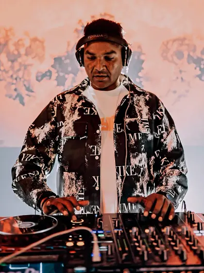 At the controls, mixing live on my Pioneer setup. This shot captures my focus during a high-energy set, ensuring every transition is seamless.