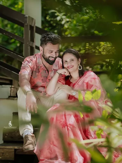 A duplicate of 275, showing a sweet, intimate moment on a wooden staircase, framed by green leaves.