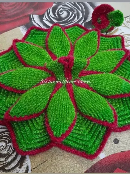 A beautiful leaf-inspired crochet dress for Laddu Gopal. This design uses green wool with a contrasting red trim to create a layered, petal-like effect, and comes with a matching two-tone cap.