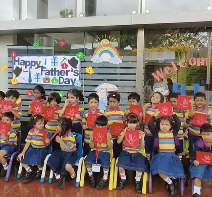 The entire class poses with their handmade Father's Day cards, their faces beaming with excitement to surprise their dads.
