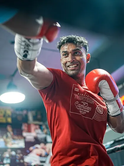 A fighter all smiles during a training session, showing his love for the sport.