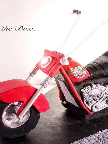 A red Harley Davidson cake, posted to celebrate the color red during Navratri, symbolizing strength and power.