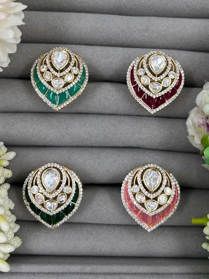 Our leaf-shaped adjustable rings, featuring a large central Moissanite stone surrounded by American Diamonds. These are available in green, red, and pink Meenakari finishes.