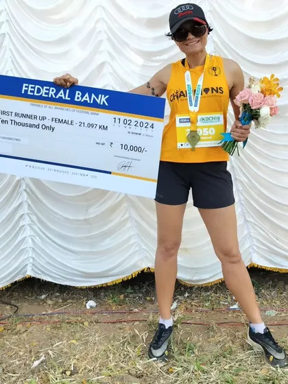 A duplicate of media 81, posing proudly with my prize check and flowers after the race.
