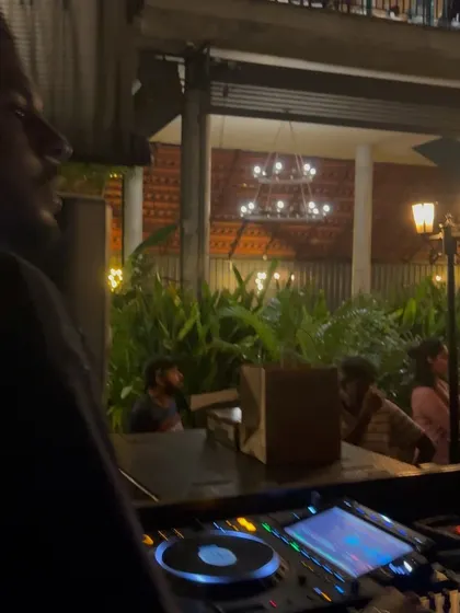 A view of my workspace at a busy event. Even with the crowd right there, my focus is on the mix.
