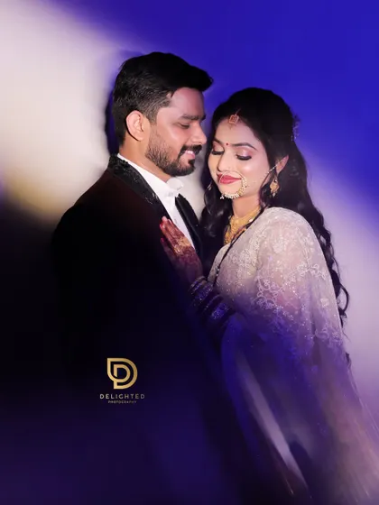 An artistic and romantic portrait with dramatic lighting, creating a dreamy, cinematic feel as the couple shares a close embrace.