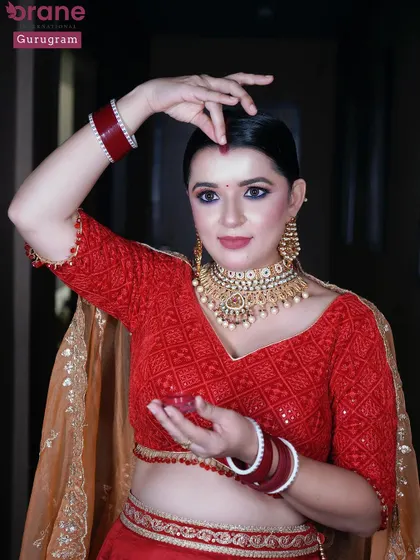 This pose highlights the traditional elements of the reception look, such as the bindi. I teach my students to be versatile in both modern and traditional styles.