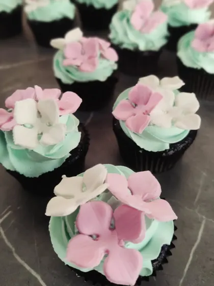 These delicate floral cupcakes were part of a Tinkerbell-themed dessert table. The mint green frosting and sugar flowers create a beautiful, enchanted look.