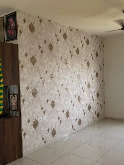 Another view of the gold damask wallpaper, showing how it complements the pooja unit and the overall room decor.