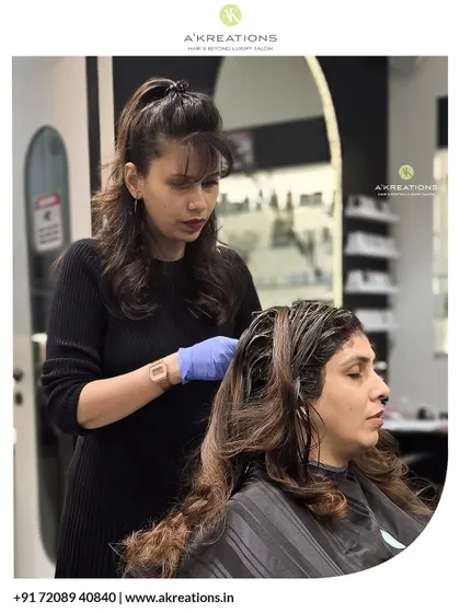 Expert hands, luxury experience. This photo captures the focus and care our Creative Art Director puts into every client's treatment.