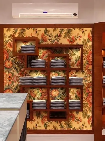 A glimpse into a retail showroom design, where we used warm wood tones and floral wallpaper to create a boutique feel. The custom shelving is designed to display merchandise in an attractive and organized manner.