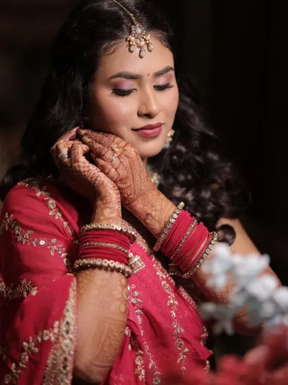 A close-up of the sangeet look. We created a soft, shimmery eye with a beautiful pink lip color that perfectly matches the tones in her outfit.