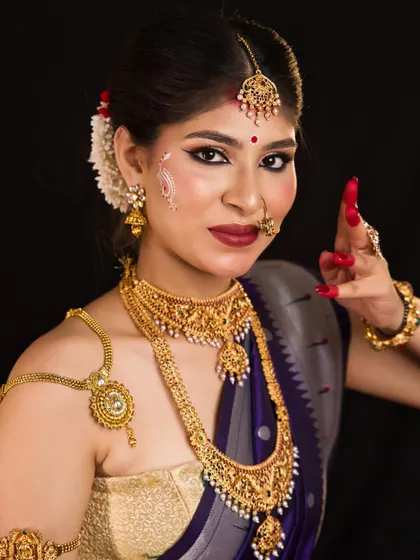 A student's portrayal of the goddess Kushmanda. The look features traditional South Indian temple jewellery and a serene expression, showcasing versatility in cultural makeup styles.