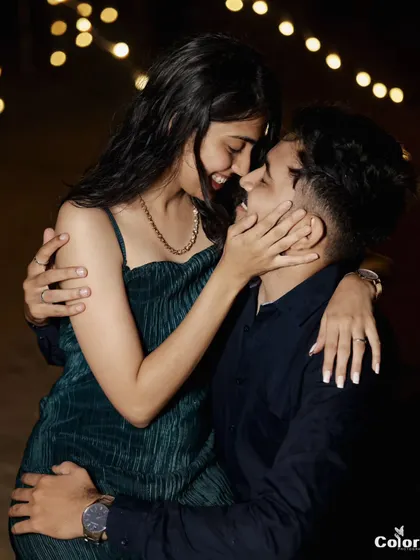 A romantic night shot with fairy lights, capturing a close and loving embrace.