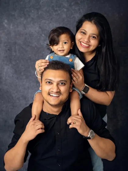 A fun and playful family pose with a toddler enjoying a shoulder ride. We love incorporating action and play into our sessions to capture your family's dynamic energy.
