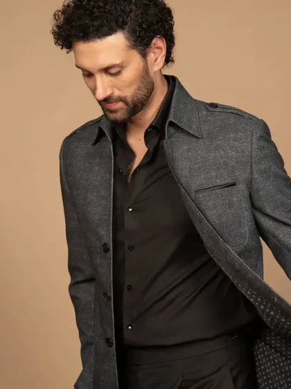 Another angle of the grey shacket, showing its lining and movement. It's a stylish and comfortable piece for effortless summer layering.