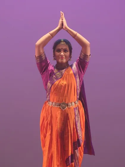 A classic Bharatanatyam pose with hands held high. This demonstrates the precise geometry and spiritual element of our Indian classical dance training.
