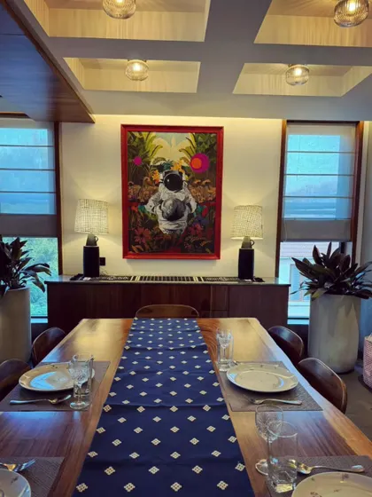 A wide shot of the dining room featuring my astronaut painting. It is fulfilling to see how a piece of my personal, surreal art can become a central part of a family's living space.