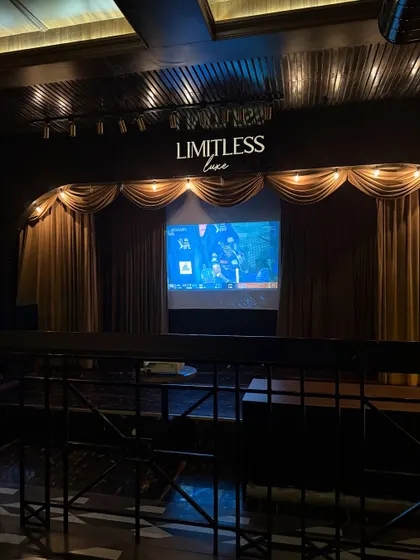 The stage and screening setup at Limitless Luxe, highlighting the venue's potential for live events and entertainment during a dine-in experience.