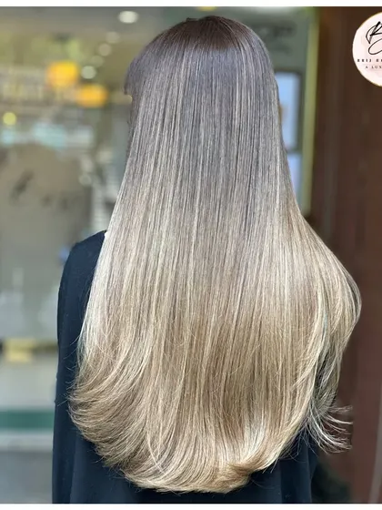 A full view from the back, showcasing the length and flawless blend of this light and luminous balayage.
