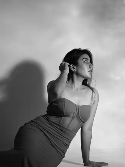 A black and white version of the 'lady in red' series. Without color, the focus shifts to the form, the light, and the cloudy texture of the background.