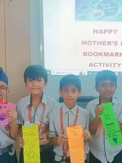 Students proudly display the bookmarks they created as gifts for Mother's Day, combining creativity with a love for reading.
