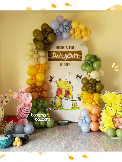 We brought the Hundred Acre Wood home for Avyan's first birthday. This charming Winnie the Pooh setup included Pooh, Piglet, and Tigger cutouts, with a beautiful organic balloon arch in honey inspired colors.