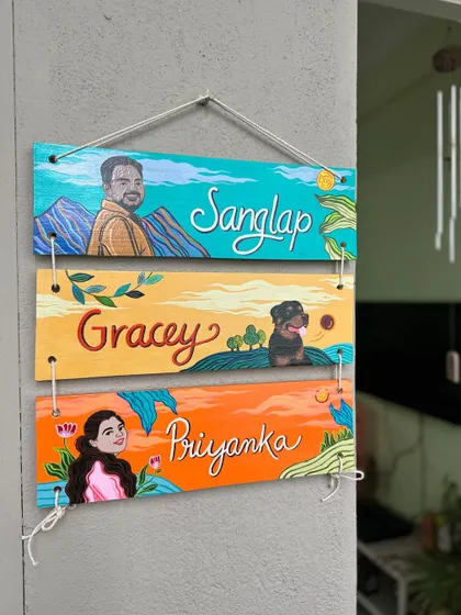 A unique, three-tier hanging nameplate I created for Priyanka's family. Each panel features a portrait of a family member, including their adorable fur baby, Gracey.