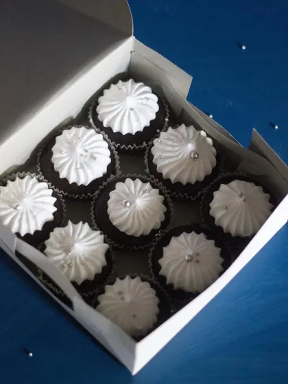 Sometimes, simple is best. This box of classic chocolate cupcakes with white meringue-style frosting was made to accompany a larger themed cake. They are a perfect, elegant addition to any dessert order.