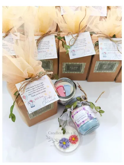 A complete baby shower gift box, showing the candle, sachet, and personalized thank you card.