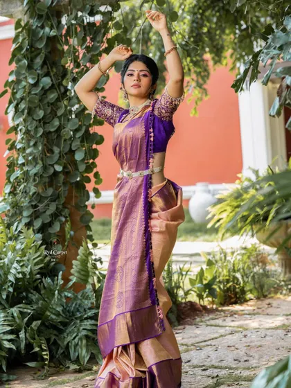 The elegance of a traditional Kanjivaram saree is timeless. Here, Megha Shetty showcases the full look, complete with a silver waist belt.