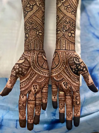 A beautiful and intricate design featuring large paisley and peacock motifs, perfect for a bride who loves classic patterns.