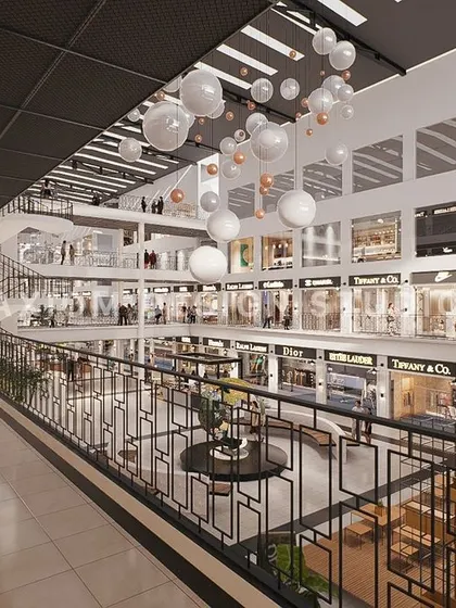 A view from an upper level, looking down into the atrium. The design uses spherical pendant lights to add a whimsical touch.