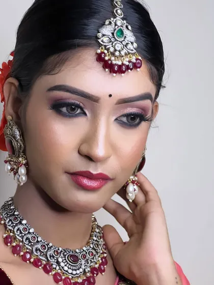 A close-up of a model wearing a beautiful Victorian-style set with ruby beads. The oxidized finish gives it a unique, antique charm.