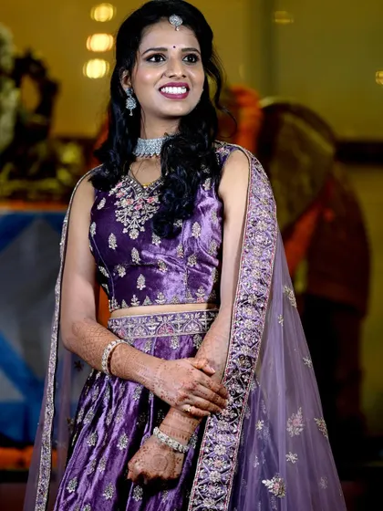 A candid shot of the bride enjoying a moment during her reception. Her smile and the soft lighting showcase the happy atmosphere of the event.