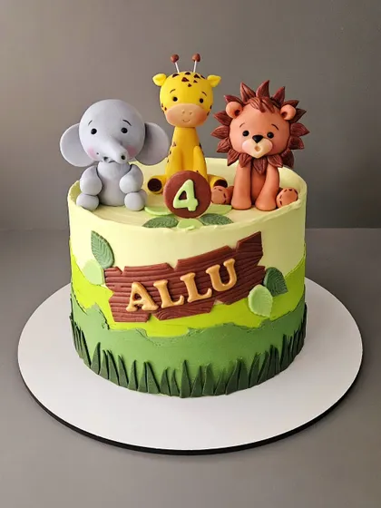Another fun jungle cake, this time for Allu's 4th birthday. This butterscotch cake is decorated with a trio of cute, hand-sculpted fondant animals: an elephant, a giraffe, and a lion.