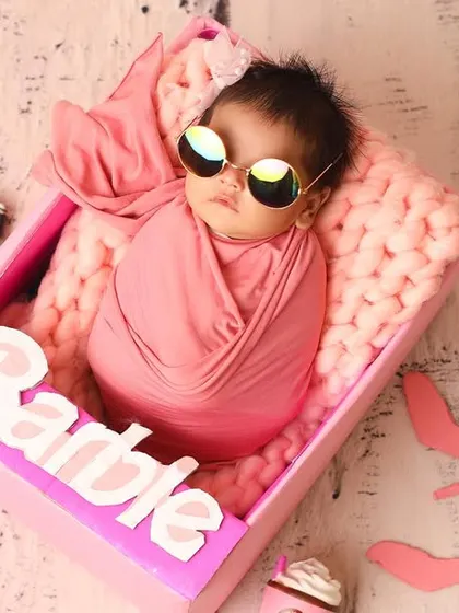 This cool little 'Barbie' is wide awake and ready for her photo op. The 'oldborn' stage is fantastic for themed shoots where an engaged expression adds to the fun.