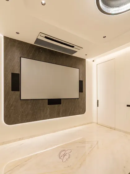 The projection screen is the star of the show, mounted on a sophisticated back-lit wall that creates a captivating focal point. The design is both modern and luxurious.