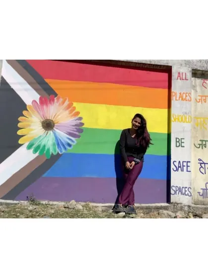 Standing proud with my "All Places Should Be Safe Spaces" mural in Seppa, Arunachal Pradesh. The progress pride flag and rainbow flower represent a hope for universal safety and acceptance.