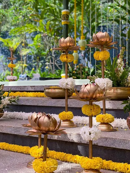 Traditional lotus-shaped lamps, adorned with marigolds, add a golden glow to the decor.
