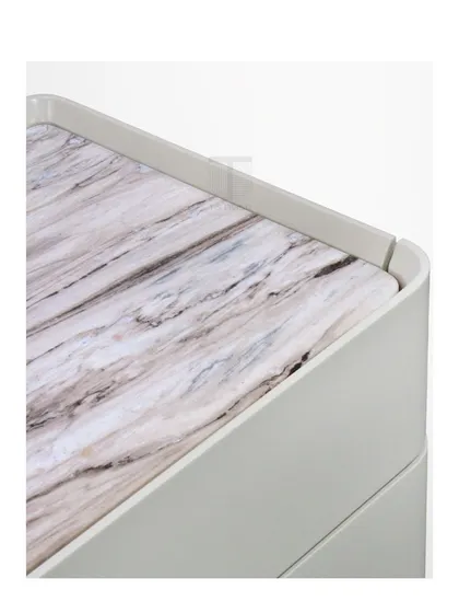 A detail of the bedside table's top, showing the beautiful grain of the marble insert.