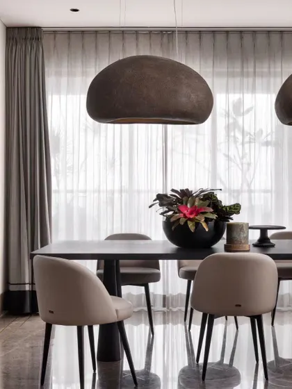These statement pendant lights were a perfect find for the dining area. Their organic, stone-like texture complements the modern furniture and adds a sculptural element to the room.