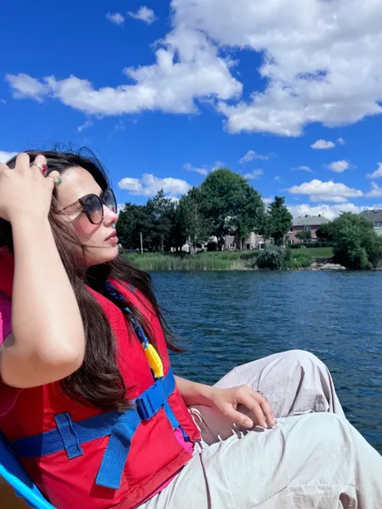 Enjoying a boat ride on a beautiful summer day with fluffy clouds in the sky.