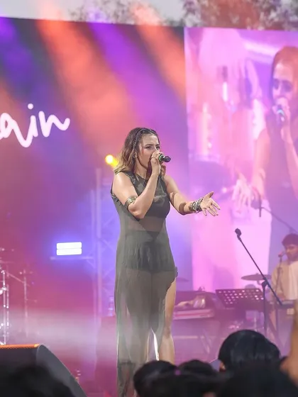 Shreya Jain performing with her full band visible in the background. I provide shots that can showcase not just the lead singer but the entire musical ensemble.